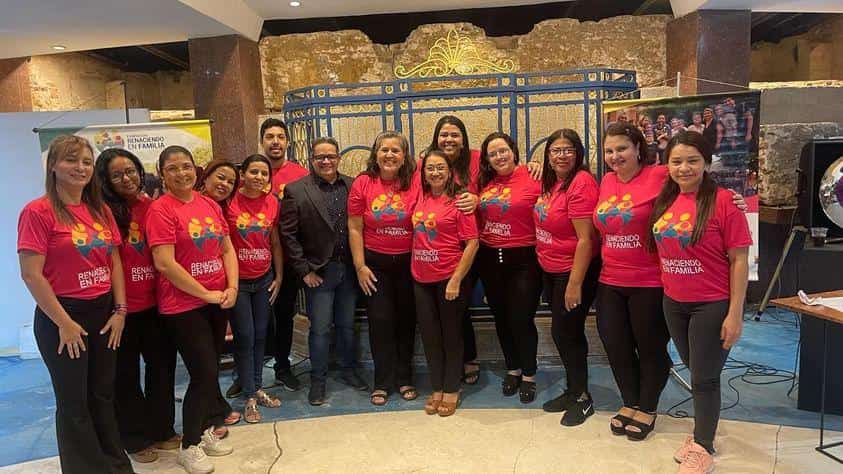 car interior from central back seat position showing driver and blurred view through windscreen of a busy road at night